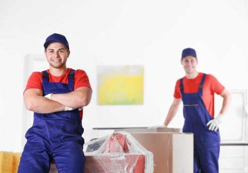 Removal team carefully handling boxed household items during a move