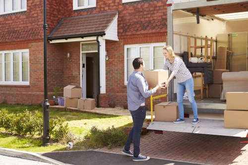 Local movers handling furniture in a Ruislip residential street