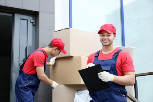 Moving boxes and furniture being handled during Ruislip removals