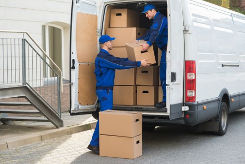Packers organising fragile household items for relocation
