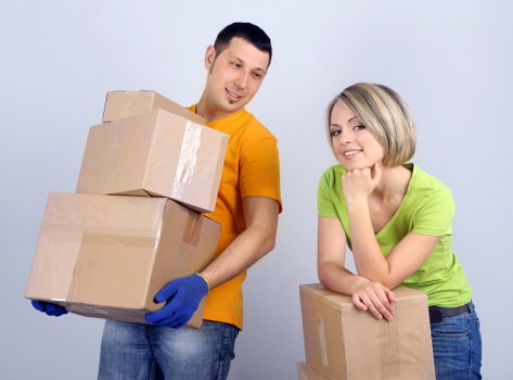 Professional moving team loading boxes into a removal van