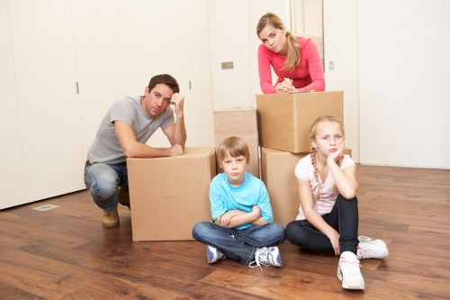 Removals professionals navigating stairs in a Ruislip flat